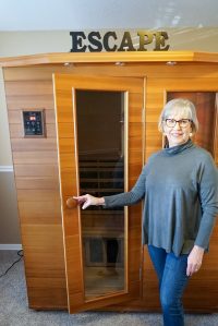 woman-standing-by-sauna-200×299-healthyspaces-northwest